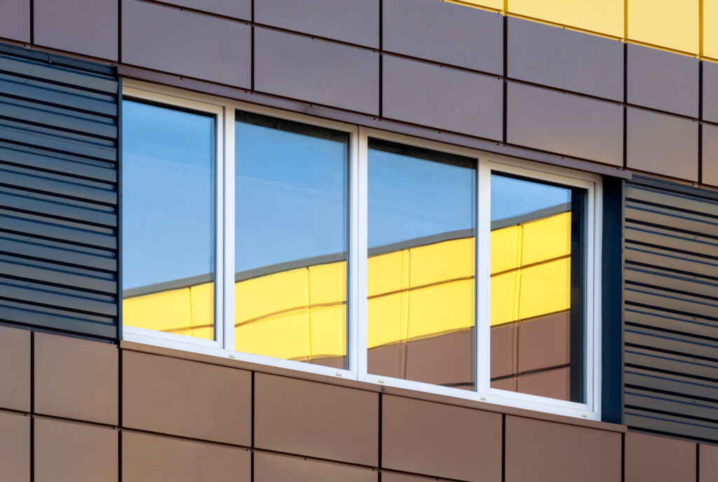 Abstract modern building exterior with colorful window reflectio